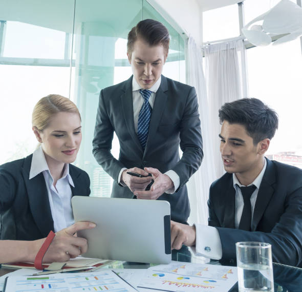 Business team meeting around a laptop